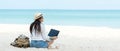 Lifestyle freelance woman using laptop working and relax on the beach.ÃÂ 